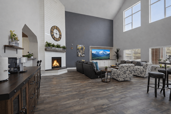 Open concept living room with vaulted ceiling and fireplace